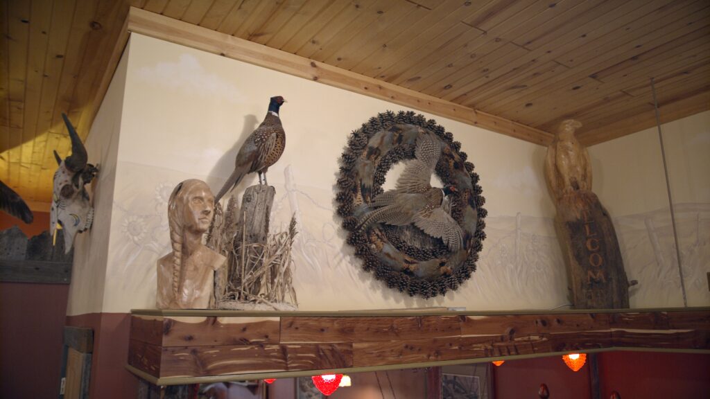 Photo of taxidermy pheasant and carved wood art at Ringnecks Lodge.