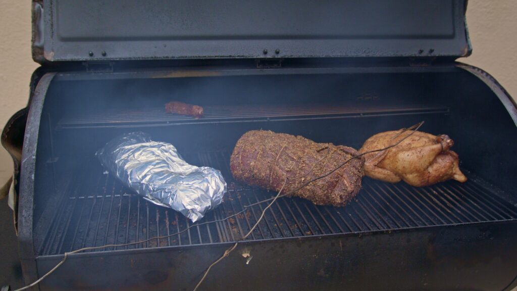 Photo of meat being smoked on smoker grill provided by Ringnecks Lodge
