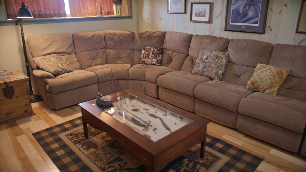 Photo of sectional couch in downstairs living space of Ringnecks Lodge.